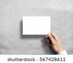 Hand holding blank white postcard flyer mockup. 6 x 4 leaflet mock up presentation. Postal holder. Man show clear post card paper. Sheet template. Invitation booklet reading first person view