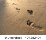 Footprints In The Sand At Sunset