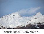 Small photo of Montagne Enneigee. Sommet de la montagne couverte de neige blanche sur fond de ciel bleu