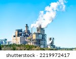 Small photo of Industrial paper mill factory plant with chimney smokestacks stacks emitting carbon dioxide emission pollution in Georgetown, South Carolina town