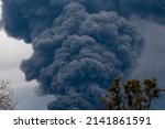 Thick black smoke covers the sky during the war between Ukraine and Russia. Disaster in Ukraine. Aggression war russia against Ukraine