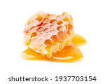Honeycomb with honey in closeup on white background