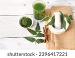 Small photo of Medicinal Neem paste , juice, and twigs with neem leaves and morter and pestle. Ayurvedic concept.