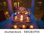 Small photo of The table (banquet apportion) laid beautifully with candles, plates and glasses for a romantic dinner