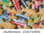 Small photo of Close up view of jigsaw pieces scattered on a calk background.