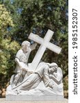 Small photo of Santa Inez, CA, USA - April 3, 2009: San Lorenzo Seminary. Station of the Cross number 7 white marble statue. Jesus falls second time. Under blue sky with green foliage in back.