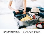 Woman Packing Travel Bag For...