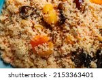Small photo of cous cous with dried fruits saffron and nuts depraved close-up. Horizontal photo