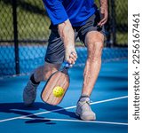 Pickleball player his a low...