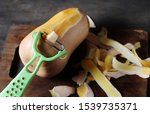 Small photo of process of cleaning pumpkin Butternut with a vegetable peeler. pumpkins purification process using peelers