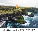 Small photo of Svortuloft Lighthouse in west Iceland highlands with stormy sea down bellow