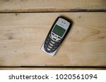 Small photo of Kajang, Malaysia- February 8, 2018 : Nokia 8310 Mobile Phone, One of the smallest Nokia handsets which included an FM radio, launched in 2000 on wooden background.