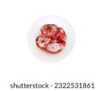Small photo of Raw chicken steaks crosswise for cooking, in a bowl on a white background