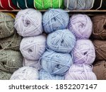 Small photo of Woolen skeins of thread for knitting are arranged according to colors. Fullscreen photo
