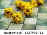 Small photo of Yellow dices for board or tabletop games on a rpg map