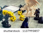 Small photo of Krasnodar, Russia, July 19, 2018: Playing Dungeons and Dragons. Miniature fugures of rpg characters, dices and dragon