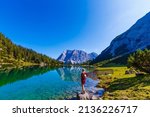 woman enjoying beauty of nature looking at mountain. Adventure travel, Europe. Woman stands on background with Alps.