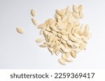 pile of toasted Pumpkin seeds on a white.