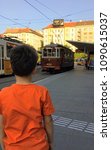 Small photo of Budapest, Hungary - May 13, 2018: Backview of a boy watching a nostalgic tram at Szell Kalman square. Szell Kalman square is an important transport hub and transit platform in Budapest, Hungary.