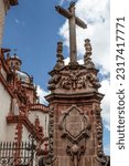 Small photo of A monument of a cross a side the Santa Prisca parish in the magical town of Taxco, in Guerrero, Mexico.