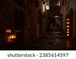 Small photo of Burning Hanukkah candles cast a glow on the cobblestone streets of the Old City of Jerusalem on the eighth night of the Festival of Lights in Israel.