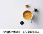 hot coffee cup and capsules on white background