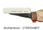 Small photo of VoIP gateway lies in palm of IT-specialist hand in black protective glove and brown uniform isolated on white background