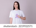 Small photo of Woman holding a purple ribbon in her hands ADD,ADHD,Alzheimer Disease ,Arnold Chiari Malformation,Childhood Hemiplegia stroke, Epilepsy, Chronic Acute Pain,Crohns