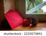 A fat envelope for letters to Santa Claus, large beautiful fir cones and a small decorative mailbox as Christmas decor lie on the windowsill in an old house. Seasonal holiday is coming
