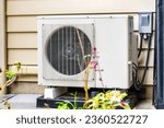 Small photo of In an outdoor setting, a newly installed mini-split system sits in the sun. This is a high efficient mini split heat pump installed by an HVAC professional.