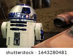 Small photo of Anaheim, California - April 16 2015: R2D2 next to a landspeeder at Star Wars Celebration 2015.