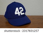 Small photo of Jefferson City, Missouri - May 31, 2023: A 42 Jackie Robinson hat on a desk in an office.