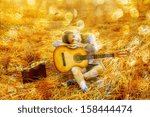 Country latin hispanic girl playing guitar at haystack Copy space for inscription With bokeh background 