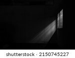 Small photo of under exposure view of a window with shutter in a living room. Aluminium louver stripe pattern sunblind windows shutter at the office building. home modern decoration.
