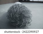 Small photo of Coil of steel wire. Rabitz mesh netting roll as background. Construction iron wire or mesh in a roll. Mesh wire rolls of iron stainless steel, galvanized metal sheets. wire mesh rolls farm fence