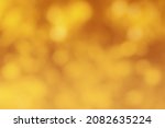 Blurred bokeh background image of bright yellow foliage in golden autumn. Abstract backdrop for design.