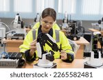 Female engineer training or maintenance AI Robot and Artificial Intelligence of Things service robot in the manufacturing automation and robotics classroom