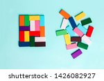 Small photo of order and chaos. Chaotic unorganized colored dominoes and ordered. Concept of business model, organization. Left and right hemisphere of the brain.