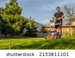 Man mowing lawn in the backyard ...