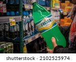 Small photo of New York NY USA-January 7, 2022 A discerning consumer chooses a bottle of Coca-Colas Fresca brand grapefruit-citrus flavored soda in a supermarket