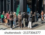 Small photo of New York NY USA-March 19, 2022 The fashion conscious celebrate the unseasonable warm weather by waiting in line at the Valentino store in Soho for a Valentino brand activation