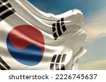 Waving flag of South Korea in beautiful sky. South Korea flag for independence day. The symbol of the state on wavy fabric.
