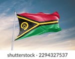 Small photo of Waving flag of Vanuatu in beautiful sky. Vanuatu flag for independence day. The symbol of the state on wavy fabric.