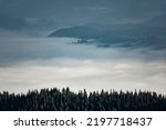 Sea of clouds in the mountain valley. Artisticalpine landscape