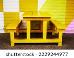                 yellow wooden bench is a perfect background. the color of fall season                  