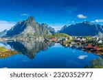 Perfect reflection of the Reine village on the water of the fjord in the Lofoten Islands, Norway