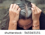 Closeup sad asian young beautiful woman and gray hair with worried stressed face expression looking down