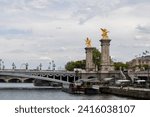 Small photo of Alexander III Bridge, Beaux Arts style, crosses the Seine River as it passes through Paris and connects the Esplanade des Invalides with the Grand Palais and the Petit Palais, Paris, France