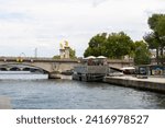 Small photo of Paris, France; 25 July, 2022: Alexander III Bridge, Beaux Arts style, crosses the Seine River, through Paris and connects the Esplanade des Invalides with the Grand Palais and the Petit Palais