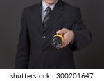 Small photo of Man holding small but powerful flashlight in his hand. Business man in black business suit is going to elucidate the situation.